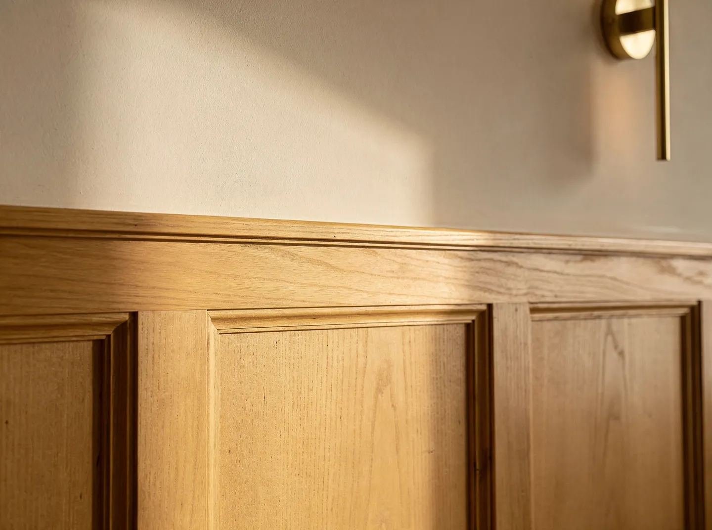 Wainscoting panels with natural light revealing the relief